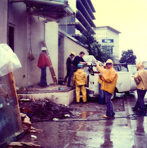 The construction crew working in the rain before the opening