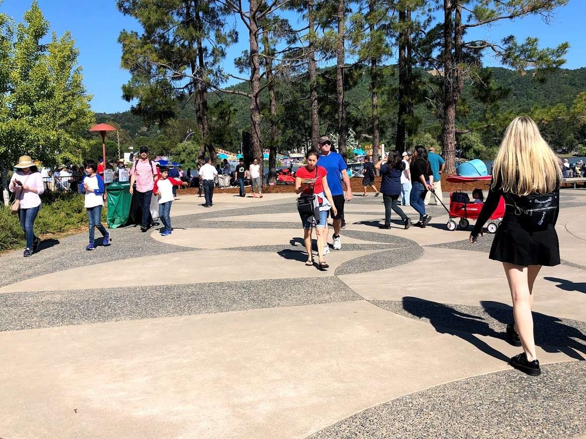 People crossing the plaza toward the auditorium
