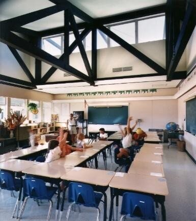 A classroom with exposed trusses and clerestory windows